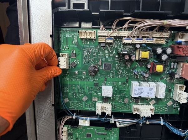 Engineer replacing a combi oven control board