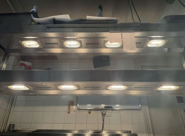 Heated gantry lamps working over a servery pass